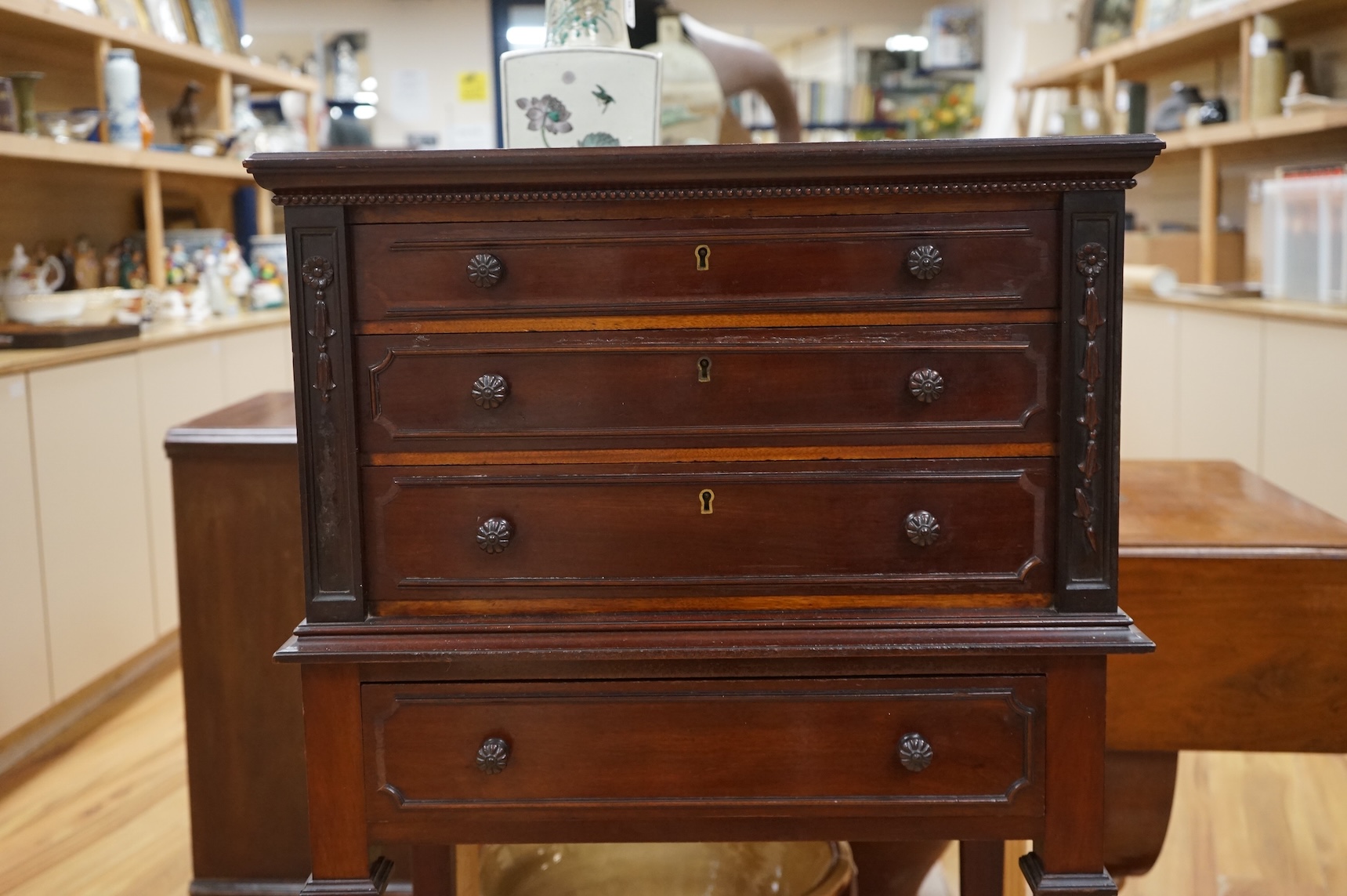 A canteen of cutlery by Viners, contained within a four drawer floor standing cabinet. 110cm tall